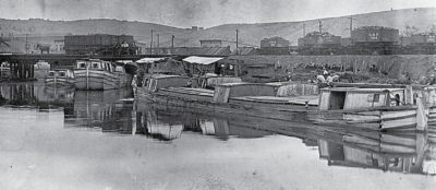Canal Boats Being Loaded With Coal From Rail Cars In Cumberland Maryland. 400x174